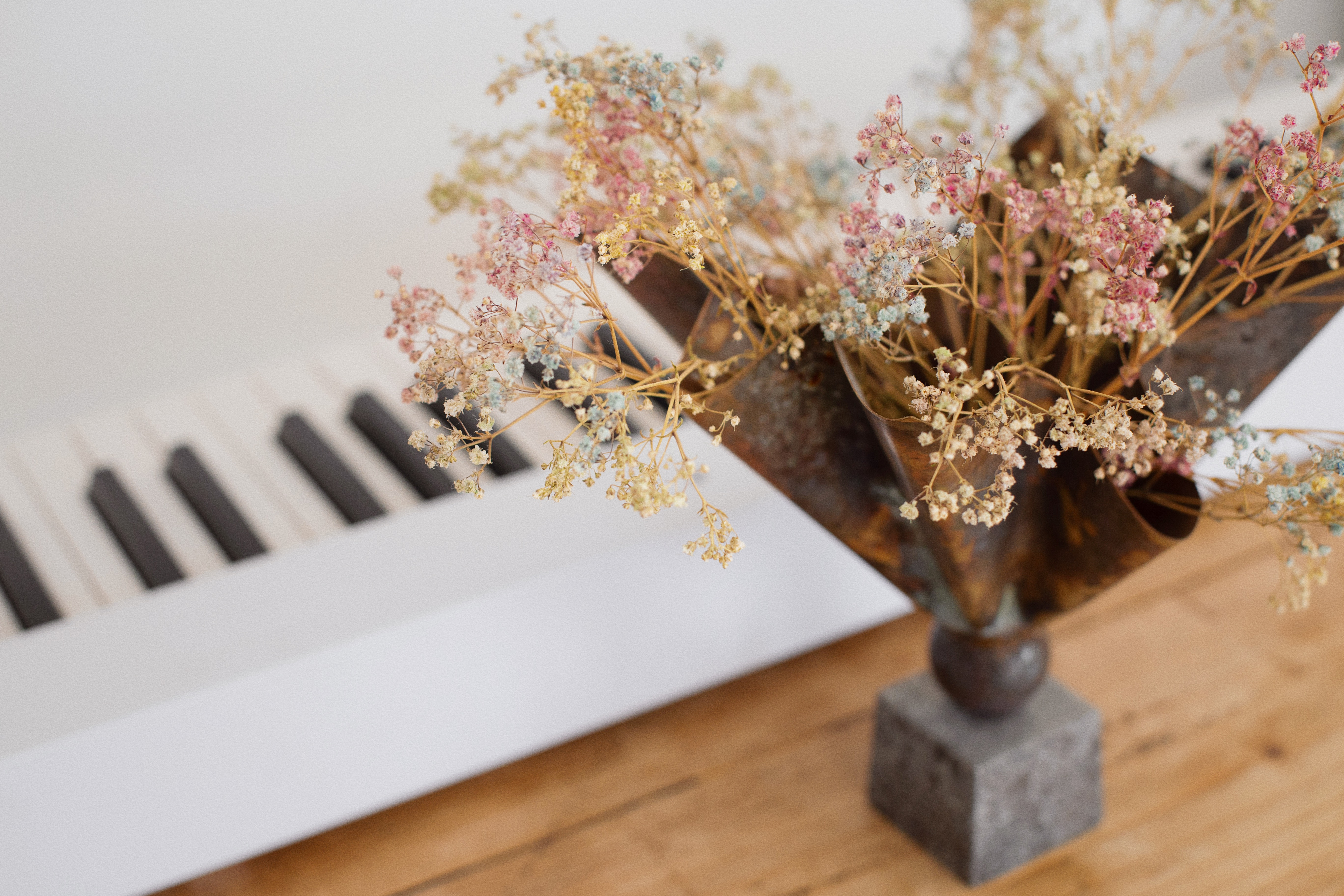 Piano keys and flowers on a wooden table